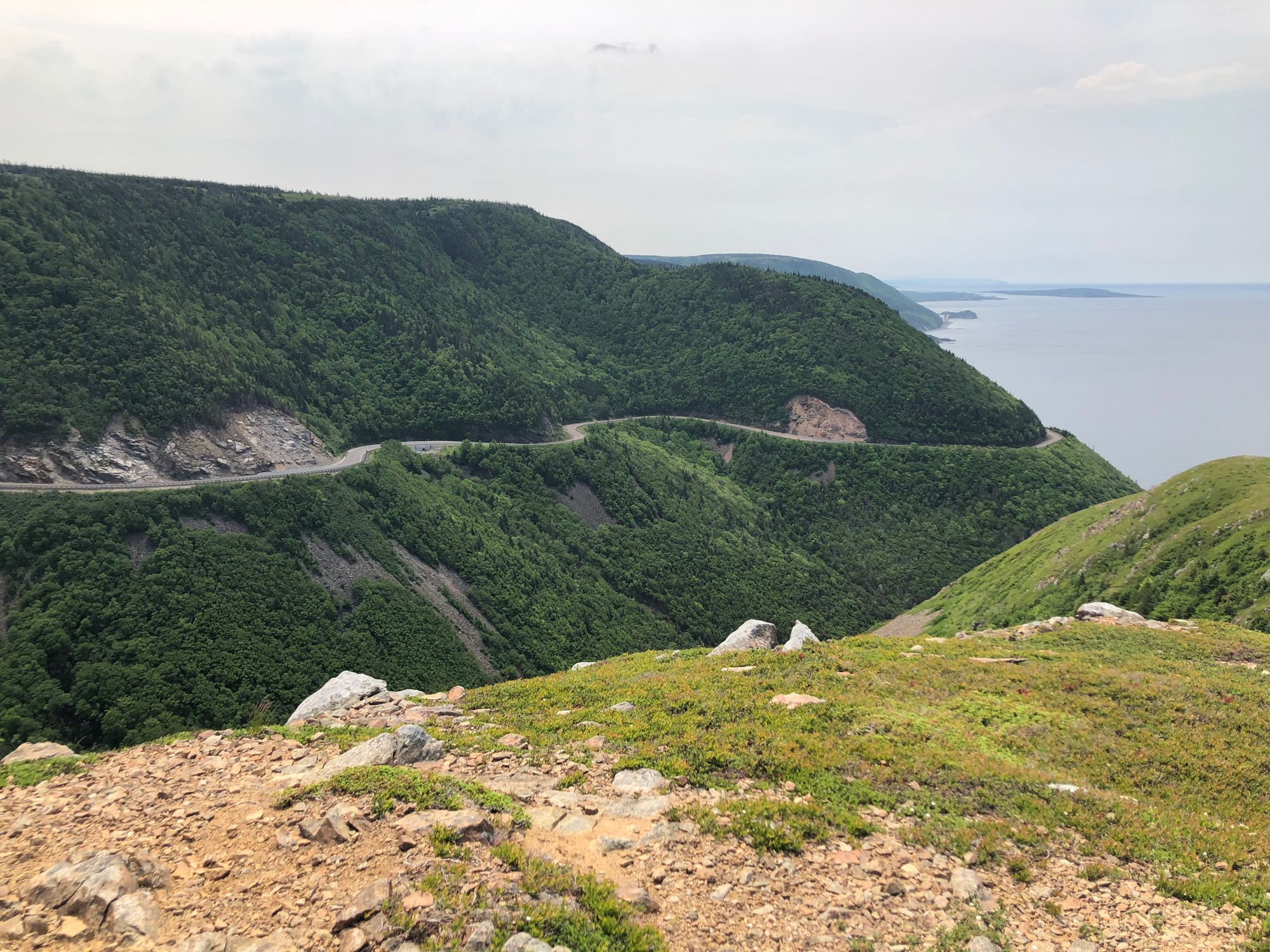 Skyline Trail in Cape Breton overlooking untouched, foliage-covered cliffs that roll for miles along the Atlantic Ocean
