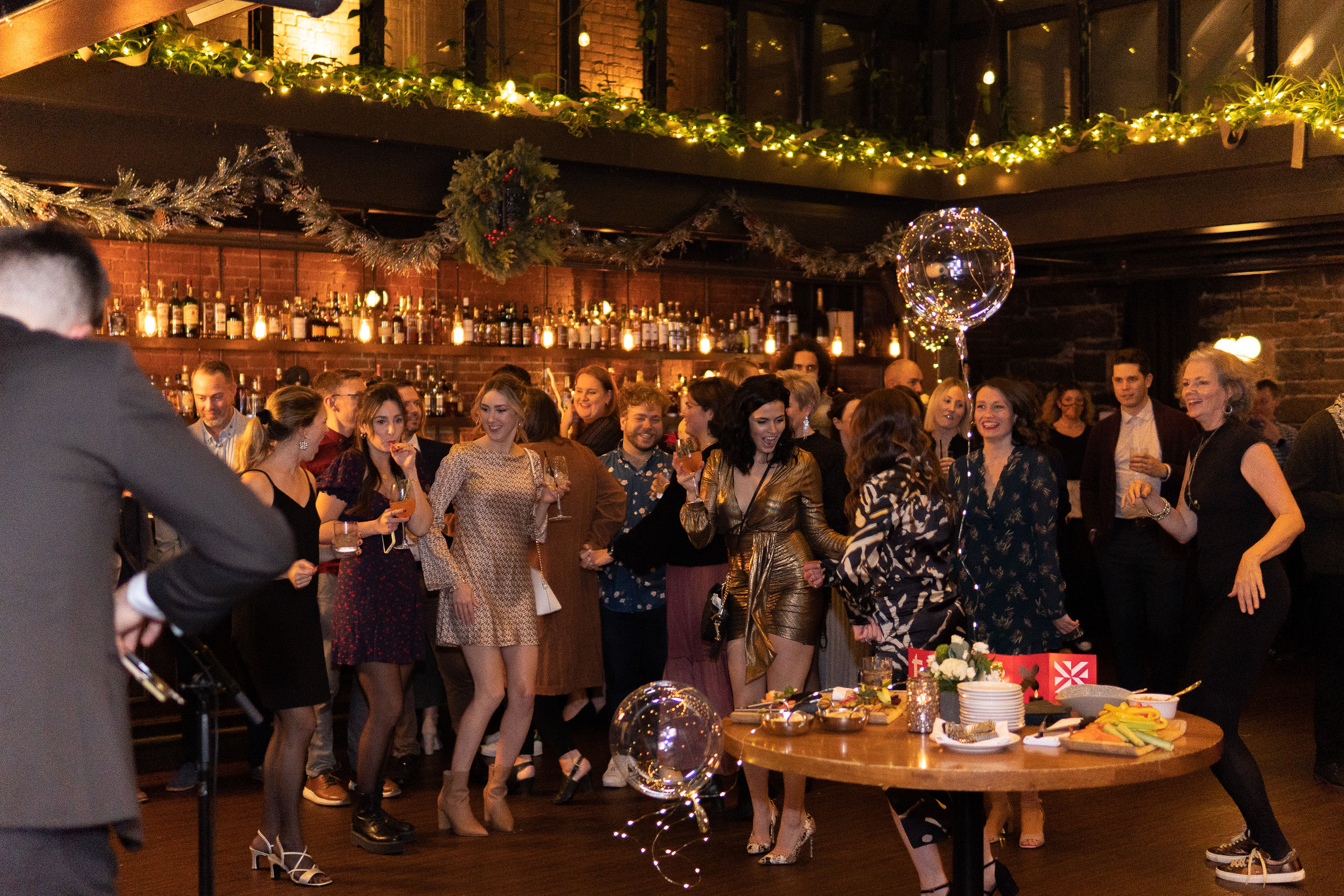 Group of staff at dressed up and dancing at a holiday party 